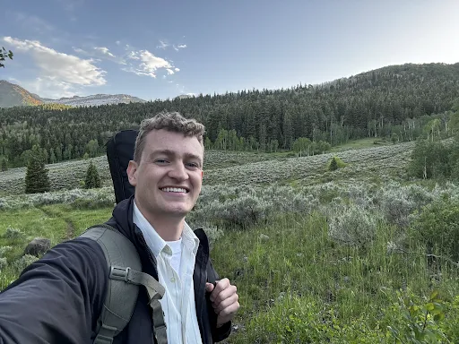 Will Holland hiking in the mountains